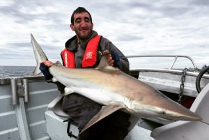 Jeremy McLoughlin with the bronze whaler shark he caught offshore from Point Impossible (Picture Kevin McLoughlin).