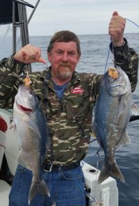 Lockie Wombell with a pair of blue eye trevalla caught while using brown trout for bait (Picture: Bob McPherson).