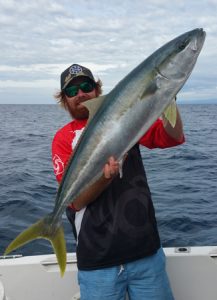 Aaron Habgood with the yellowtail kingfish he caught outside Port Phillip Heads on Sunday (Picture: Aaron Habgood).